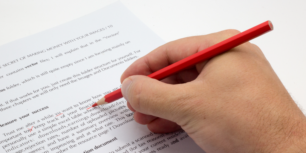 Someone fine-tunes a document in red pencil.