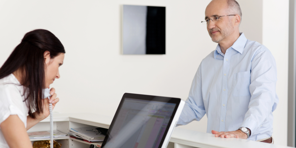 A patient is checking in at the hospital's registration desk