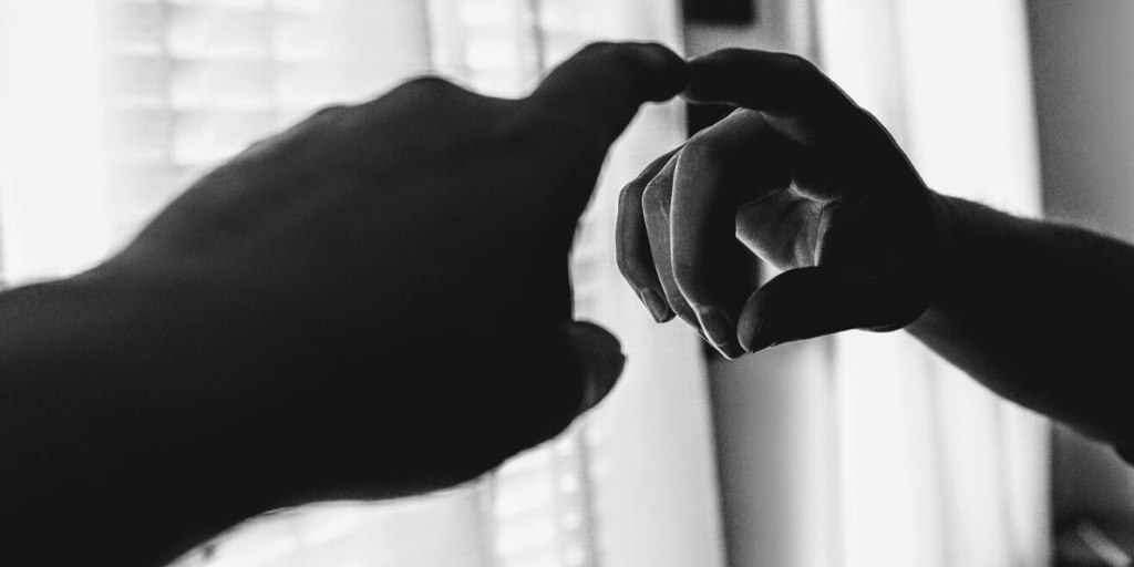 Two people come into contact by touching fingers