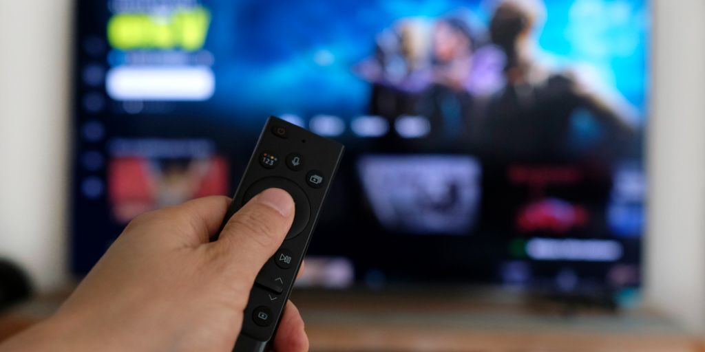 A remote control with a streaming platform in the background