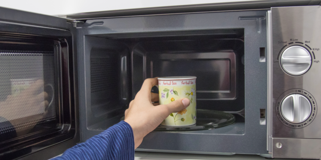 A cup of coffee in a microwave