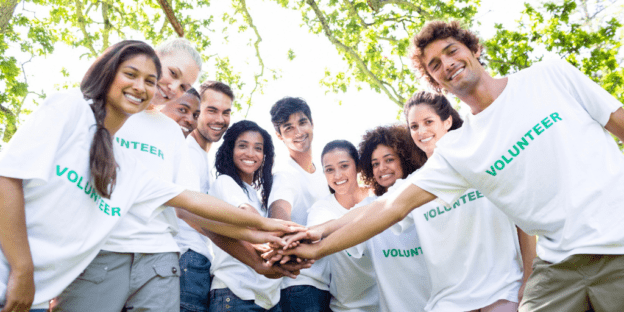 A group of young people preparing to volunteer in a park