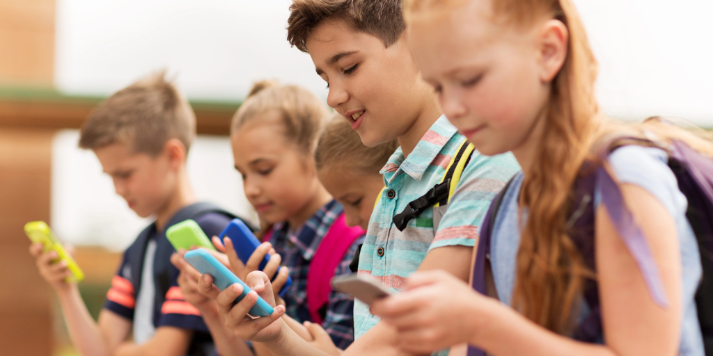 Young students looking at their cell phones